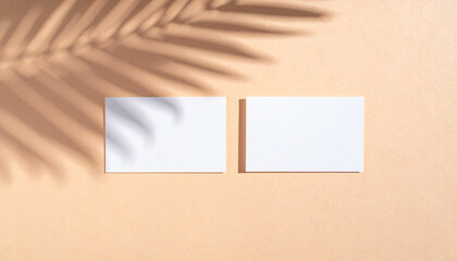 Simple brand mockup with blank envelope or two business cards on a brown background, soft leaf shadows and natural light.