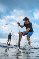 Focused man enjoying a paddleboard challenge