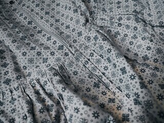 The motif and background of the fabric depict small flowers