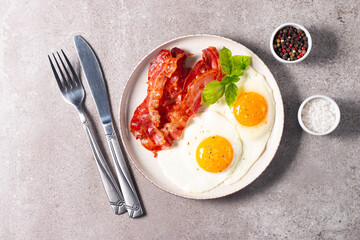 Delicious traditional English breakfast with fried eggs and bacon