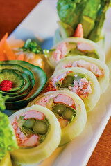 sushi platter with fresh seafood, cucumber, wasabi, and soy sauce