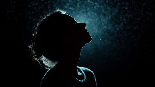 Profile silhouette of a woman against a dreamy, bokeh-filled backdrop, evoking mystery and contemplation.