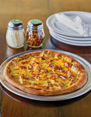 uncut veggie pizza with grated parmesan cheese and red pepper