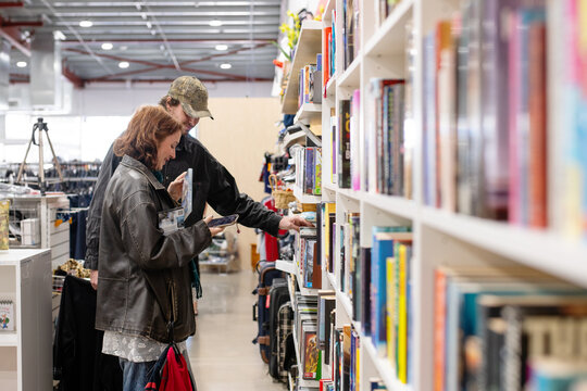 a genZ couple shopping in a thrift store