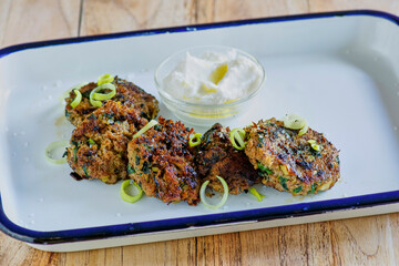 ground lamb and leek patties served with a yogurt tahini sauce