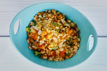 middle eastern cauliflower rice salad with almonds, dried fruit, and fresh herbs, overhead angle