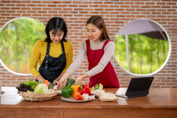 Two women are preparing food together in a kitchen