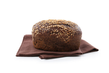 Loaf of rye bread with sesame seeds and towel isolated on white