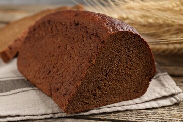 Pieces of fresh rye bread on wooden table, closeup