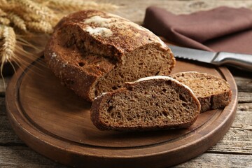 Pieces of fresh rye bread on wooden table, closeup