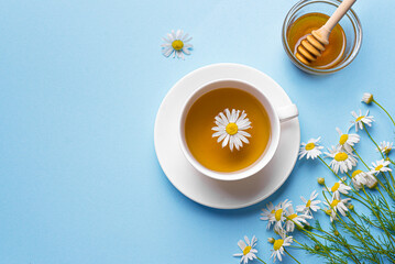 Chamomile tea cup and chamomile flowers