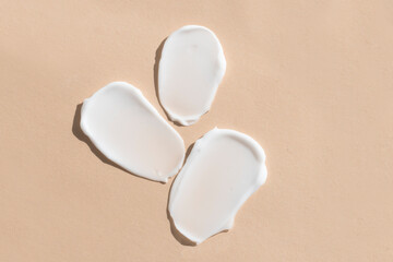 Smears, texture of white cosmetic cream for moisturizing and caring for the skin of the body.