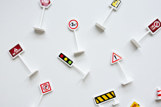 Assorted miniature traffic signs on white background