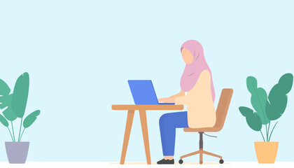 Focused Muslim woman in a pink hijab and casual clothes typing on a laptop at a modern wooden desk.