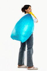 A woman with a blue trash bag poses on a white background