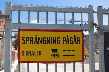 Sign warning about explosions iat construction site in Gothenburg, Sweden