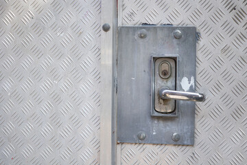Fortified door handle and lock on steel door