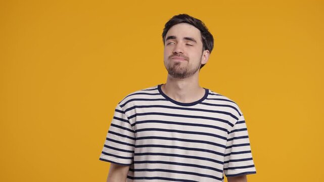 Tired Annoyed Man Sighs, Rolls Eyes On Yellow Background. Displeased Expression