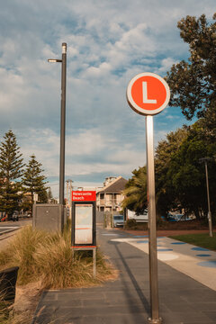 Light rail stop at Newcastle Beach with red L sign