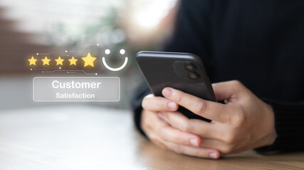 Customer satisfaction review with a 5-star rating on a smartphone screen, showing feedback, quality service experience, user review, and digital customer engagement.