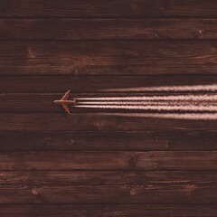 Obraz premium Miniature airplane in flight over wooden planks.