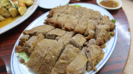 close up of Cantonese dish taro duck, whick is roasted crispy duck with Taro, moist duck wrapped in a blanket of mashed taro root
