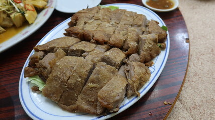 close up of Cantonese dish taro duck, whick is roasted crispy duck with Taro, moist duck wrapped in a blanket of mashed taro root