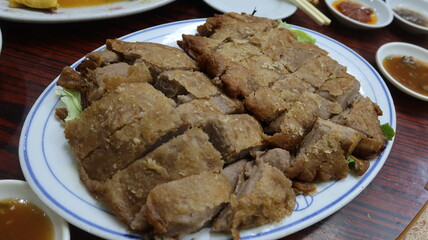 close up of Cantonese dish taro duck, whick is roasted crispy duck with Taro, moist duck wrapped in a blanket of mashed taro root