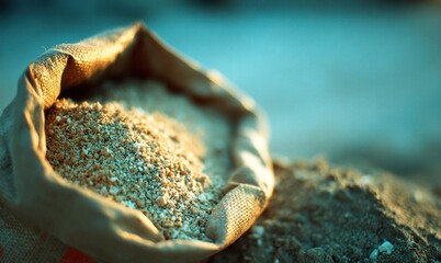 Fototapeta premium Sack of sand on a construction site during early morning light in a serene outdoor environment