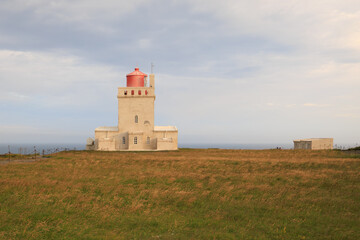 Lighthouse surrounded by grass