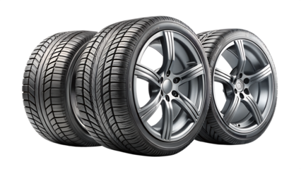 Photo of three car tires with alloy rims arranged in a row isolated on transparent background