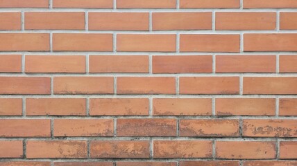 Orange brick fence, old brick fence with stains and black marks, old orange brick wall texture background, close-up photo of the wall.
