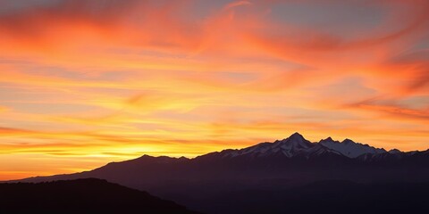 Fototapeta premium Serene sunset over majestic mountain range, ideal for wall art or fabric, background, landscape