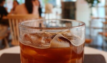 Close-Up of Iced Coffee Glass in a Cozy Cafe Setting