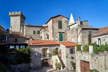 Stone houses and the tower of a medieval castle in Capalbio