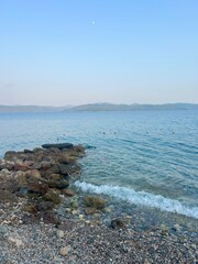 The calm Mediterranean Sea at dusk with distance views of mountains