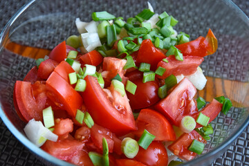 Chopped tomatoes, chives and onion in a bowl