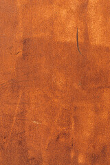 A textured surface with a warm, rusty orange hue. The background features subtle scratches and imperfections, creating