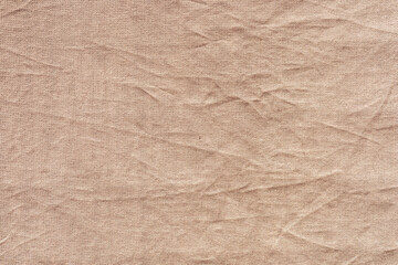 Textured beige fabric with visible wrinkles and folds. The surface soft and natural, suitable for various design applications.
