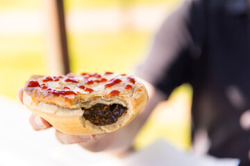 pie with tomato sauce on top with a bite taken out of it