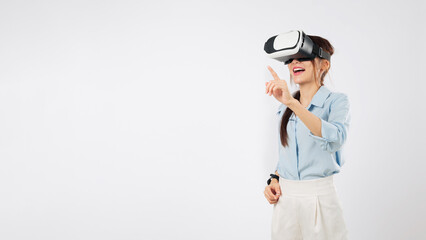 Asian woman with vr headset exploring virtual reality tech, pointing a finger toward futuristic interface, further enhances immersive vr experience with intuitive controls, isolated white background