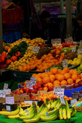 Stalls at the fresh fruit and vegetable market show off colourful fruits and vegetables with price...