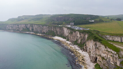 Aerial view on Cliffs and coast of Atlantic Ocean, Carrick a Rede Rope Bridge in Ballintoy, Northern Ireland. 