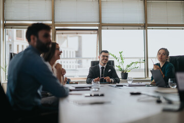 A diverse team of business people engaged in a collaborative meeting in a modern office setting. They are discussing ideas and working together with focus and creativity.