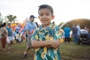 Happy little boy enjoy outdoor theme park festival