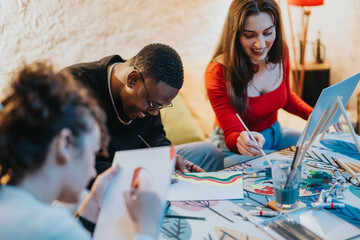 Three friends gather around a table, joyfully engaging in painting activities, expressing their creativity amidst good company in a cozy indoor setting.