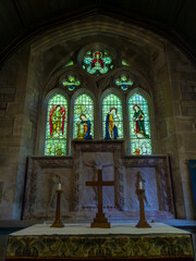 Fototapeta premium Altar and stained glass window in The Parish Church of Saint Mary (Lower Slaughter, Gloucestershire, England, United Kingdom)