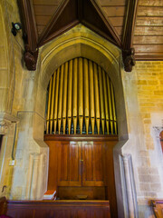 Golden organ pipes inside The Parish Church of Saint Mary (Lower Slaughter, Gloucestershire, England, United Kingdom)