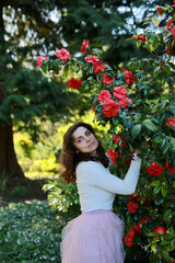 A Young Woman Enjoys a Beautiful Flower Garden Filled with Vibrant Blooms and Colors