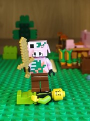 Naklejka premium Minecraft Lego Piglin Barbarian Standing Over Fallen Minifigure